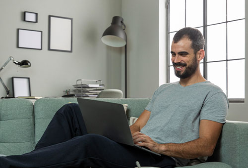 smiley-man-working-from-home-laptop